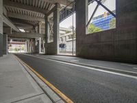 a street is empty in this city area of an elevated area with large windows and no one is on the ground