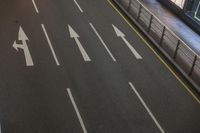 the streets and signs are both empty at night with no people on it and a person crossing