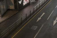 the streets and signs are both empty at night with no people on it and a person crossing