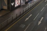 the streets and signs are both empty at night with no people on it and a person crossing