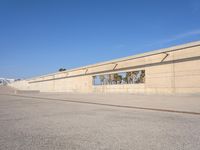 the empty concrete ramp at an airport with buildings in the background on either side of the road