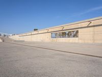 the empty concrete ramp at an airport with buildings in the background on either side of the road