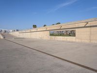 the empty concrete ramp at an airport with buildings in the background on either side of the road