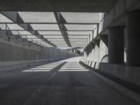 there is a long empty concrete road in the city of la habraca, mexico