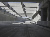 there is a long empty concrete road in the city of la habraca, mexico