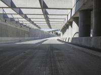 there is a long empty concrete road in the city of la habraca, mexico