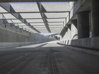 there is a long empty concrete road in the city of la habraca, mexico