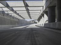 there is a long empty concrete road in the city of la habraca, mexico