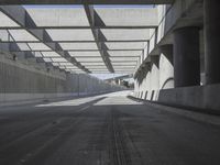 there is a long empty concrete road in the city of la habraca, mexico