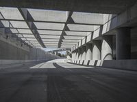 there is a long empty concrete road in the city of la habraca, mexico