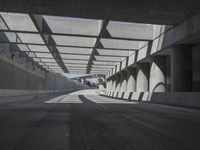 there is a long empty concrete road in the city of la habraca, mexico