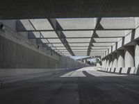 there is a long empty concrete road in the city of la habraca, mexico