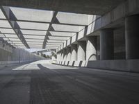 there is a long empty concrete road in the city of la habraca, mexico