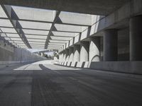 there is a long empty concrete road in the city of la habraca, mexico