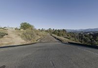 an empty country road is pictured on this clear day in the hills around the area