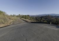 an empty country road is pictured on this clear day in the hills around the area