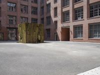 the courtyard is empty and there is only one person outside in this photo on the street