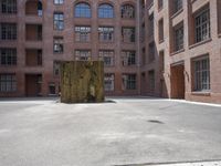 the courtyard is empty and there is only one person outside in this photo on the street