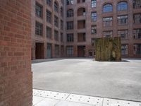 the courtyard is empty and there is only one person outside in this photo on the street