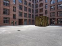the courtyard is empty and there is only one person outside in this photo on the street