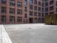 the courtyard is empty and there is only one person outside in this photo on the street