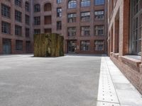 the courtyard is empty and there is only one person outside in this photo on the street