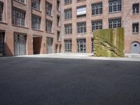 the courtyard is empty and there is only one person outside in this photo on the street