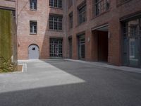 the courtyard is empty and there is only one person outside in this photo on the street