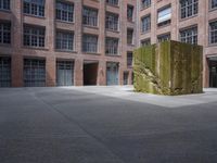 the courtyard is empty and there is only one person outside in this photo on the street