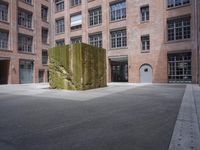 the courtyard is empty and there is only one person outside in this photo on the street