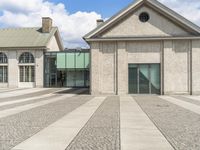 this is an empty courtyard near some buildings and a glass door in the middle of it