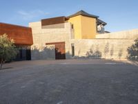 the courtyard at this modern house is empty of people, with one on fire hydrant near by