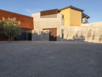 the courtyard at this modern house is empty of people, with one on fire hydrant near by