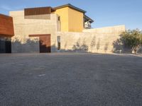 the courtyard at this modern house is empty of people, with one on fire hydrant near by