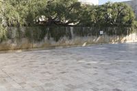 a person rides an electric skateboard through the courtyard of a museum in israel and it is empty