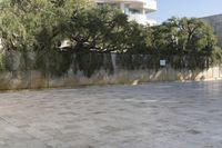 a person rides an electric skateboard through the courtyard of a museum in israel and it is empty