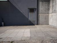 an empty courtyard is shown in front of a building with an open door and no one in the center