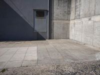 an empty courtyard is shown in front of a building with an open door and no one in the center