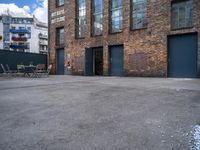 the empty courtyard with wooden tables and chairs is shown in a photograph with red brick walls