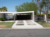 an empty driveway with no cars on the side and no trees on the other side