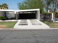 an empty driveway with no cars on the side and no trees on the other side