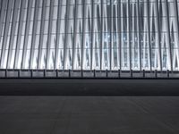 there is an empty floor in front of a tall building with many windows, and several glass walls