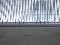 there is an empty floor in front of a tall building with many windows, and several glass walls