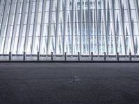 there is an empty floor in front of a tall building with many windows, and several glass walls