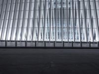 there is an empty floor in front of a tall building with many windows, and several glass walls