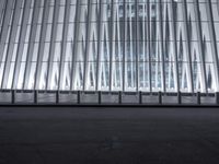 there is an empty floor in front of a tall building with many windows, and several glass walls