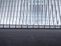 there is an empty floor in front of a tall building with many windows, and several glass walls