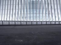 there is an empty floor in front of a tall building with many windows, and several glass walls