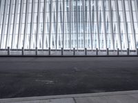 there is an empty floor in front of a tall building with many windows, and several glass walls