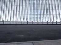 there is an empty floor in front of a tall building with many windows, and several glass walls